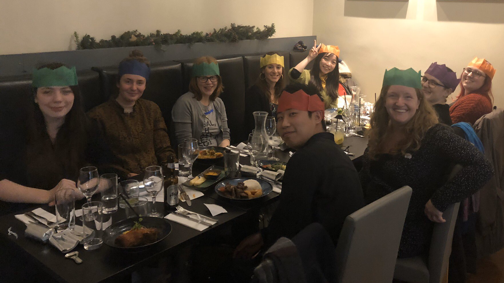 Smiling faces sitting around a table